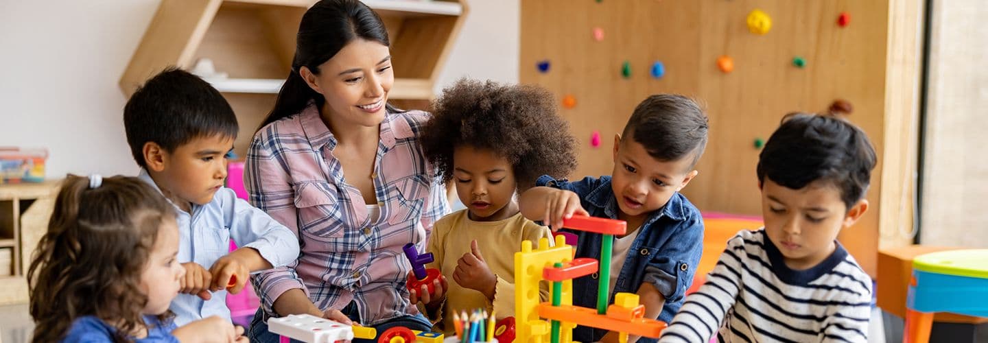 a preschool teacher works with her class