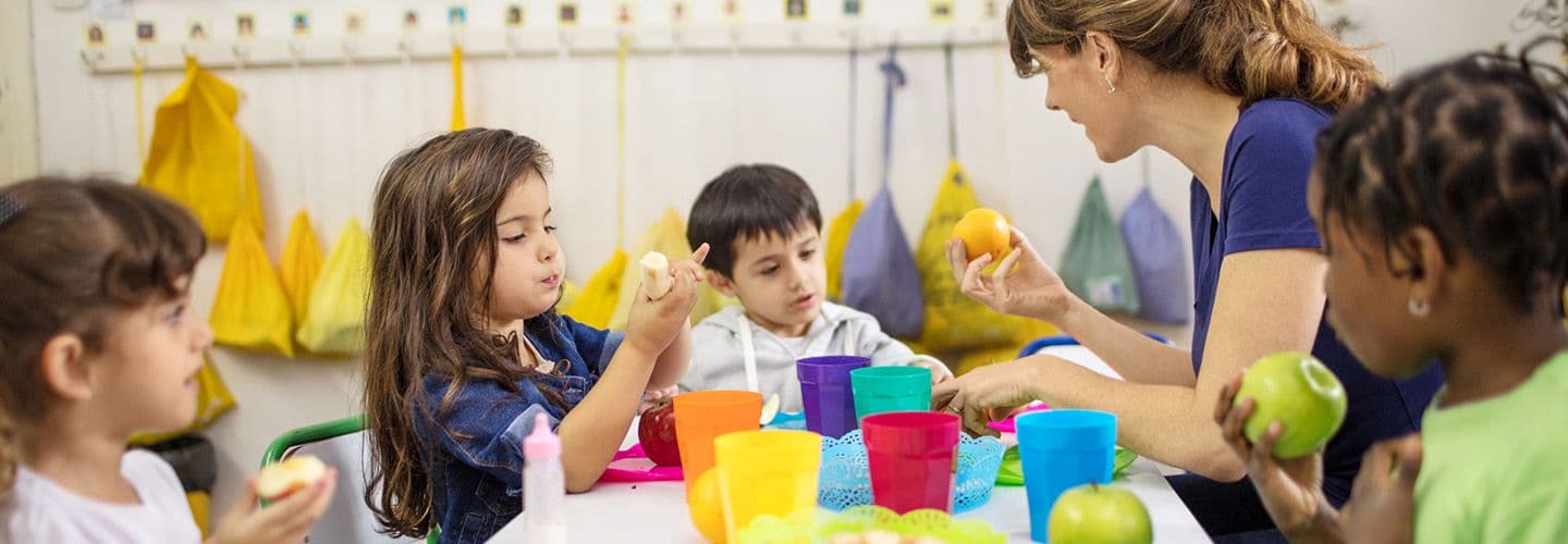 a teacher explains fruit to her students