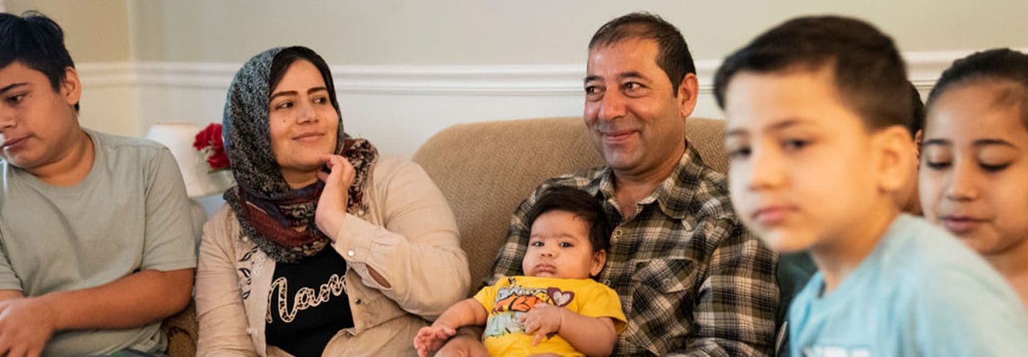 a family sitting together on the couch