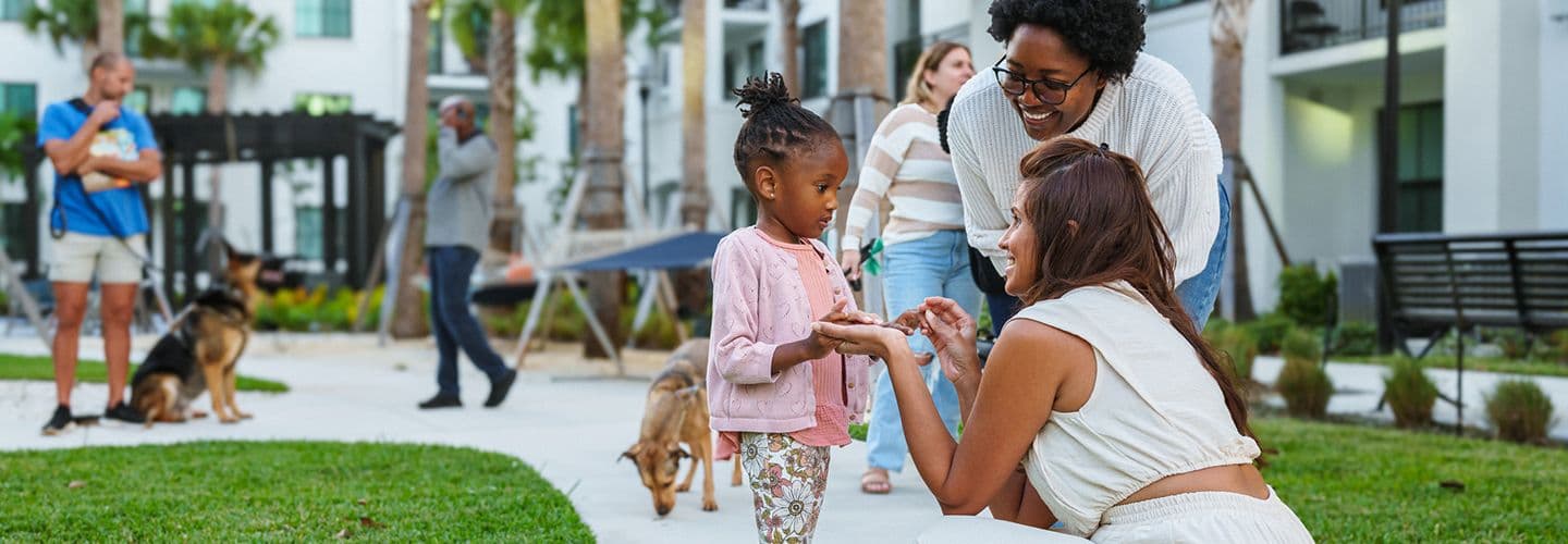 a little girl at the park with her mom and aunt