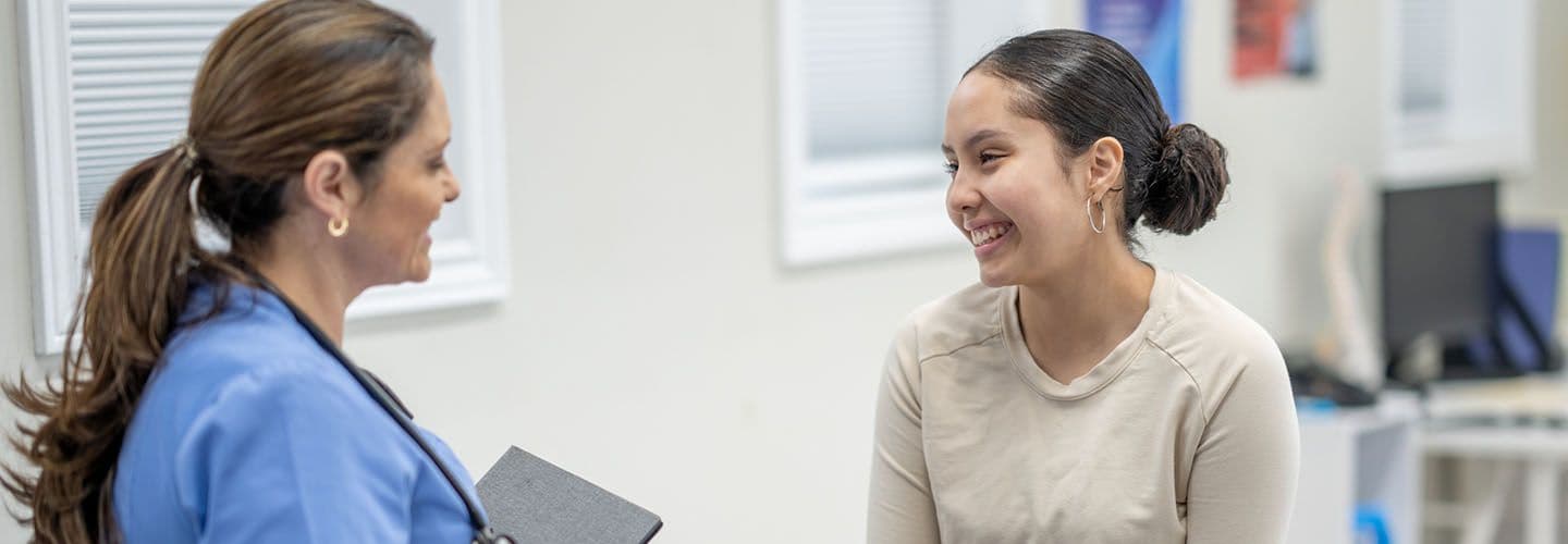 a young woman talks with a doctor