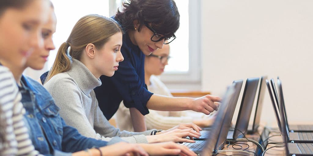 a young woman learning computer coding
