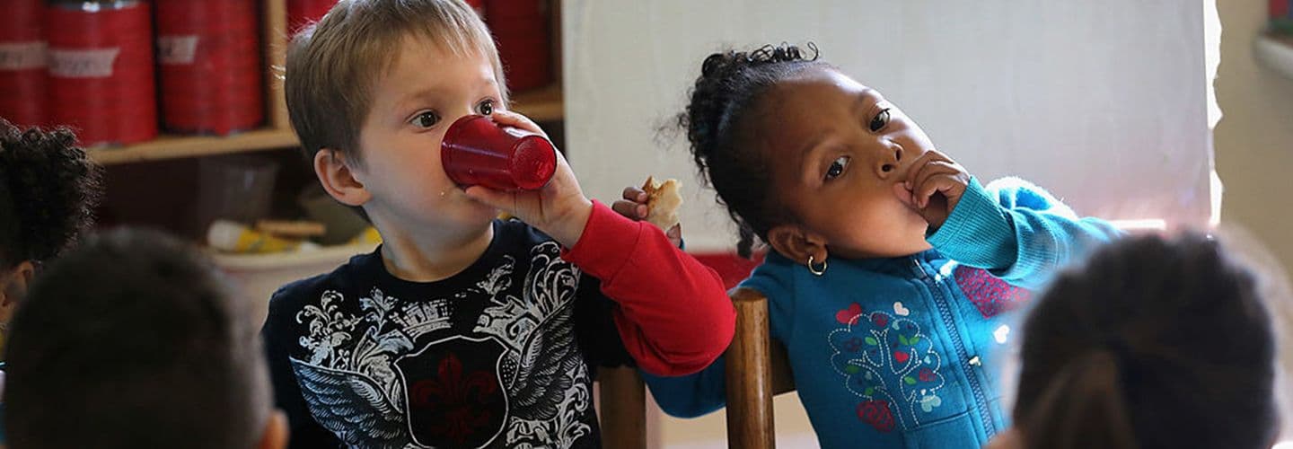 young children eat breakfast at daycare