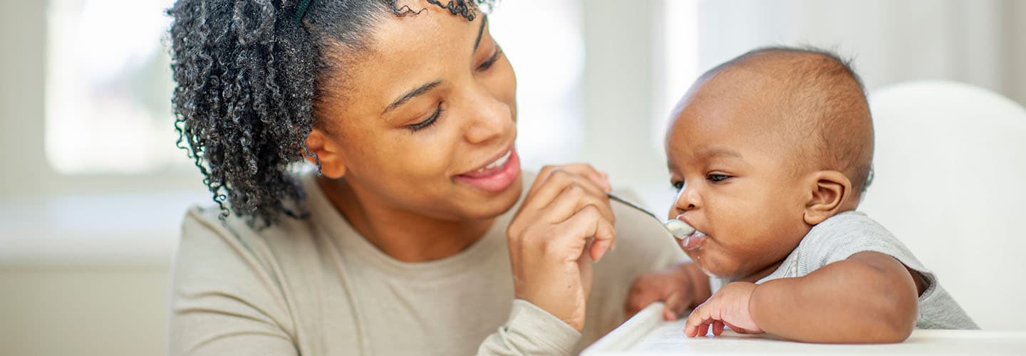 a young mom feeds her baby