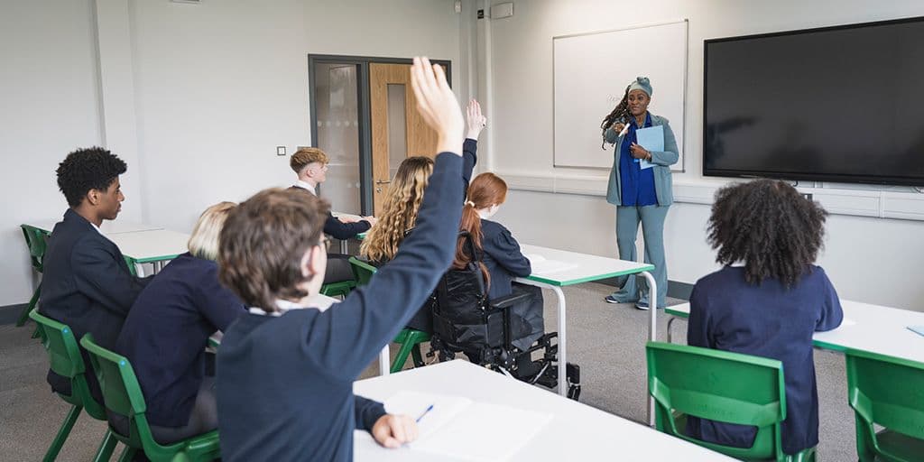 a student raises their hand in class