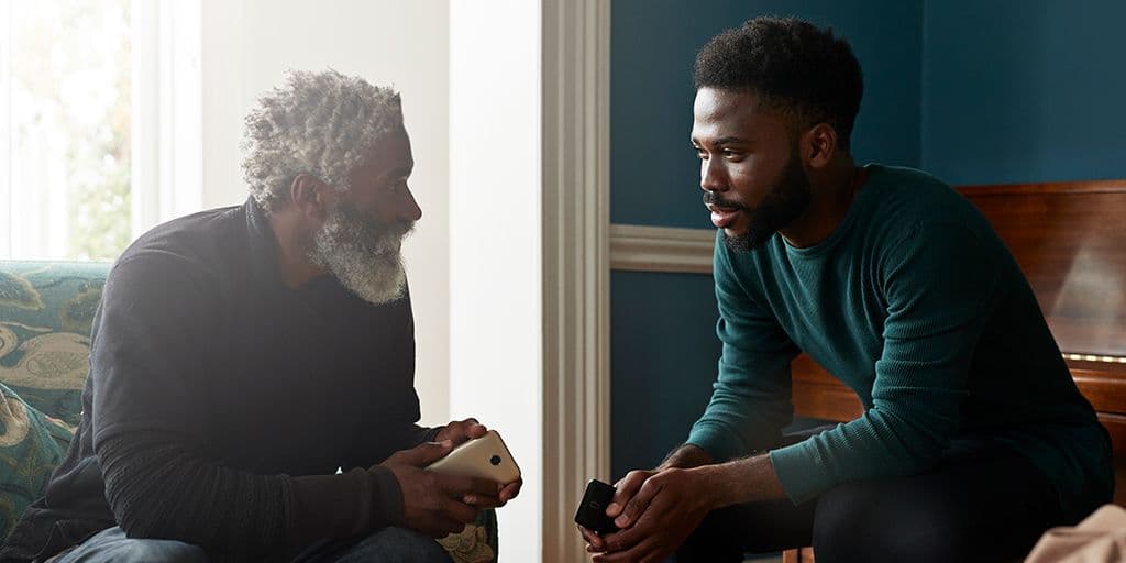 a young man talks to an older relative