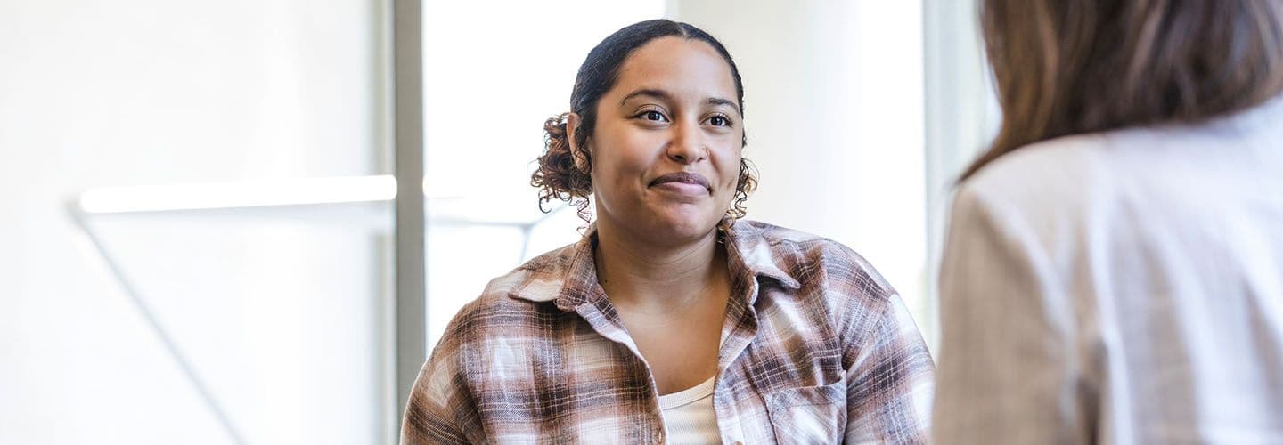a young woman talks to a counselor