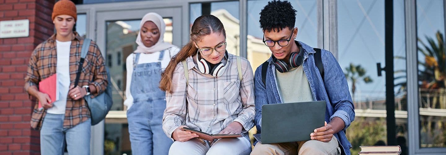 friends study together outside at school