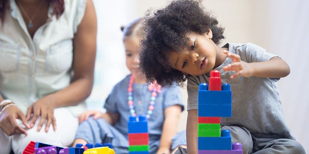 a young child plays with blocks