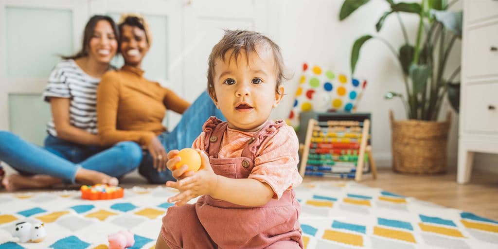 a couple at home with their baby