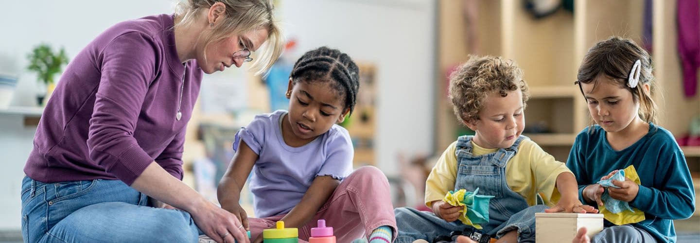 a group of young children learn with a teacher
