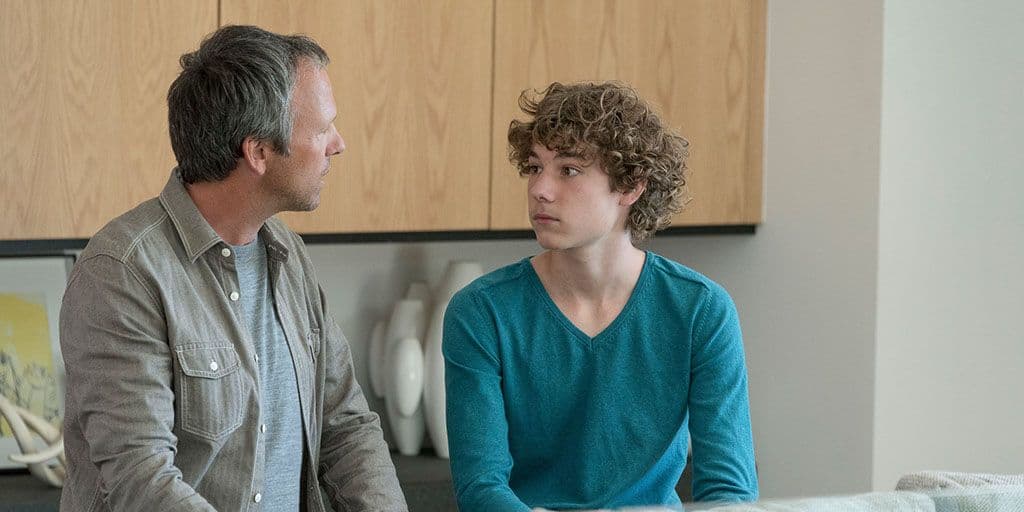a father and son have a serious conversation