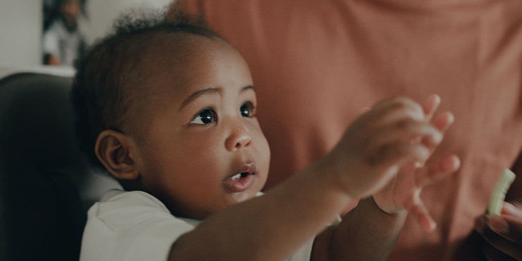 a young baby looks off camera
