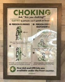 Image in a restaurant with instructions about how to care for someone choking