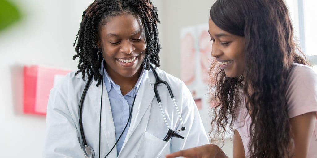 a young women goes over healthcare options with her doctor