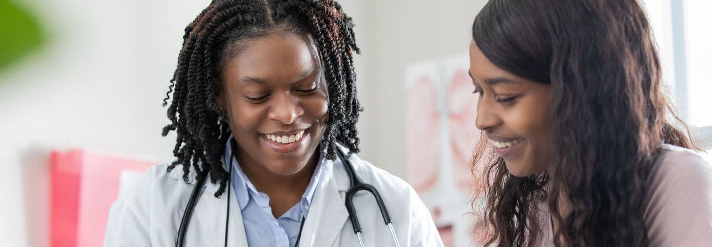 a young women goes over healthcare options with her doctor