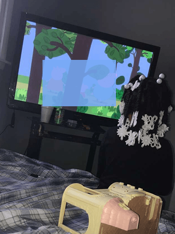 A little girl watching television