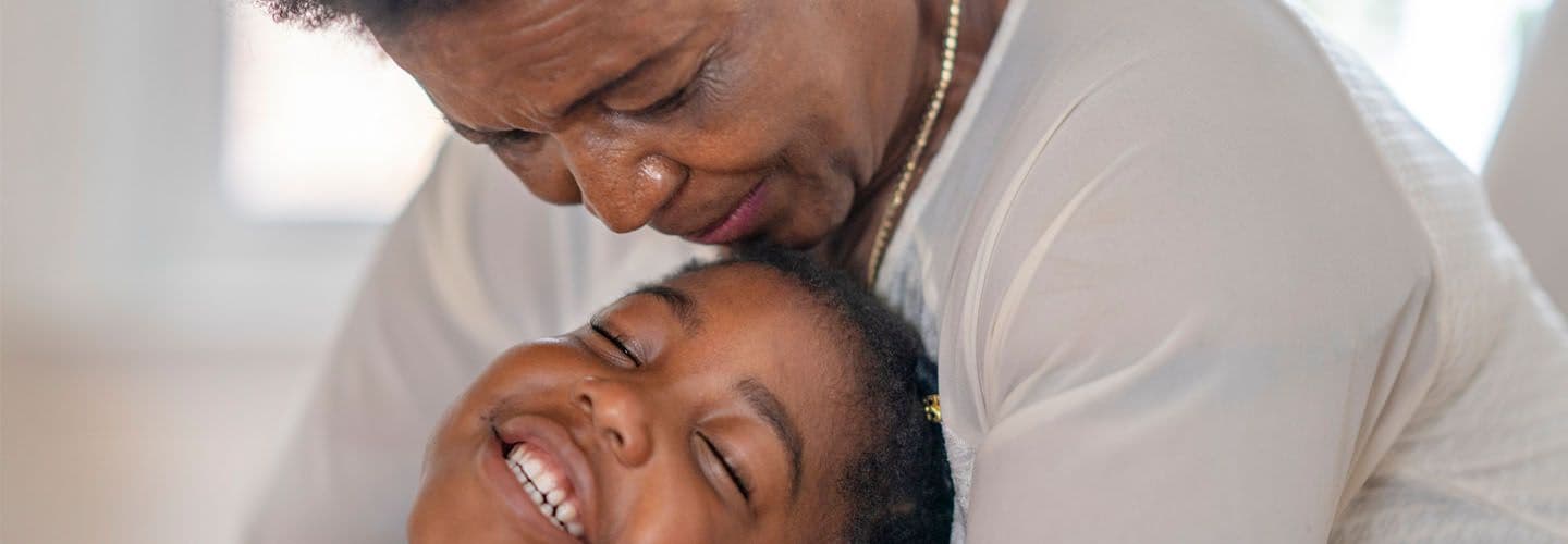 a grandmother and granddaughter hug