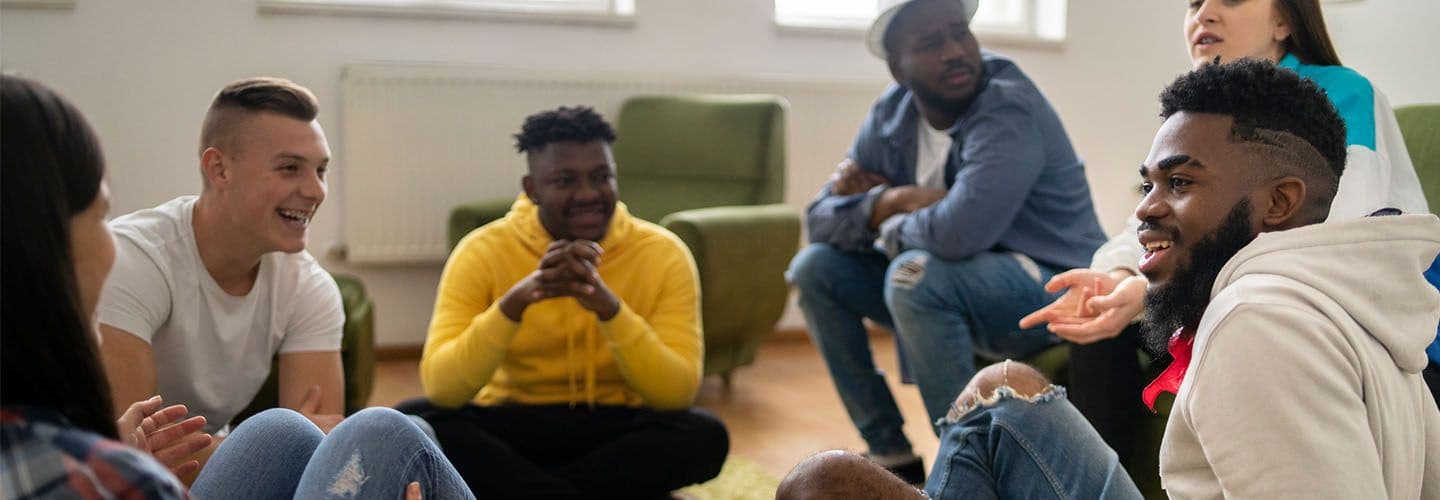 a group of friends sit and talk together