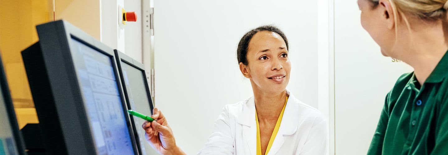 Doctor Talking About Patient X-Rays With Technician