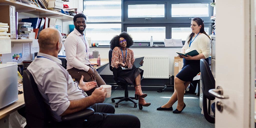 teachers meet and have a conversation in an office
