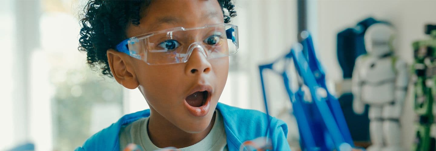 a young boy uses a remote control in a STEM project