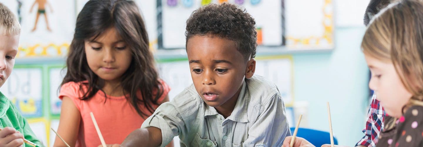 young children play with paints at day care